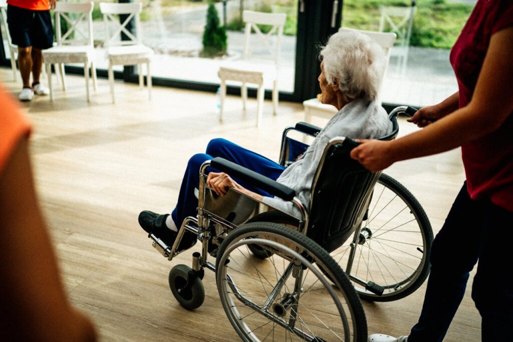 pexels-photo-16364306 A caregiver assists a senior adult in a wheelchair at a nursing home in Prague, Czech Republic.