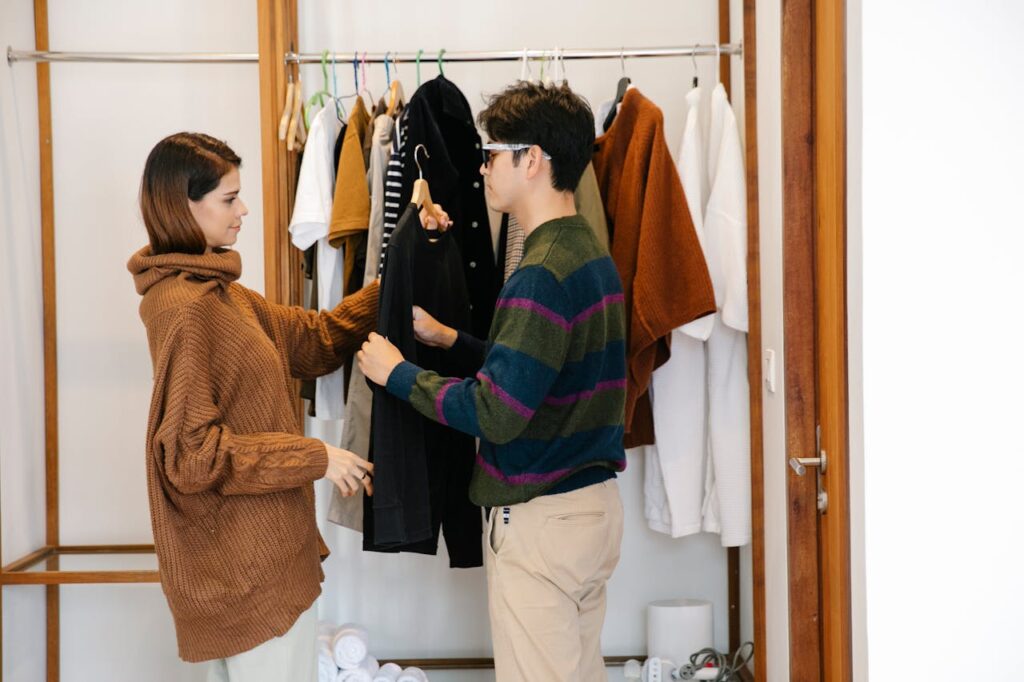 pexels-photo-7188582 A woman helps a visually impaired man choose an outfit in a wardrobe.